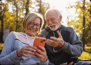 Pareja sonriendo mientras miran su teléfono juntos